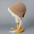 Detail of hand-crocheted straw hat showing intricate hollow patterns and white lace trim - M (56-58cm) / Khaki