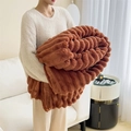 Thick caramel faux rabbit fur blanket with ribbed texture held by a model - 100*150cm / Rabbit Plush Caramel