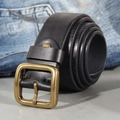 Vintage men leather belt with antique brass buckle on blue denim jeans background - Black