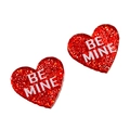 Close-up of glittery red heart earrings with white Be Mine text for Valentine's Day - Red Heart Be Mine Lettering