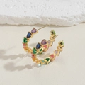 Detail of C-shaped gold hoop earrings featuring multi-colored heart-shaped zircon stones - Colorful Heart Zirconia Style (ES2283) / Gold
