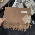 Brown cashmere-feel scarf with fringe tassels and branded tag in a lifestyle setting - 200x68cm / Dark Camel
