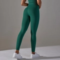 Close-up of honeycomb textured dark green high waist yoga pants showing lifting effect - Dark Green