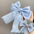 Elegant light blue triple-layered bow hair clip with pearlescent finish and metal grip - Sky Blue Spring Clip