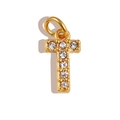 Macro shot of a gold T-shaped pendant with seven sparkling white zircons and hanging ring - Letter T / Gold