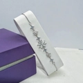 Silver four-leaf clover bracelet with white cat-eye stone and star charms in a purple gift box - White Gold