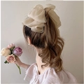 Elegant beige fabric bow banana clip worn on a high ponytail for a minimalist chic look - Khaki Bow