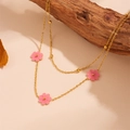 Detailed close-up of double-layer gold necklace with pink flower charms on wood - Pink Shell Necklace (L506)