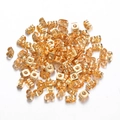 Detailed pile of bulk golden butterfly earring backs made of premium stainless steel - Gold