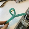 Hand holding a 13cm green twisted hair claw clip with a strong golden metal spring - 13cm Hanger Type / Misty Green