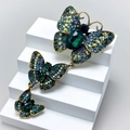Vintage gold butterfly brooch featuring emerald green crystals and a tiered chain design - Style 69/Long Emerald Butterfly