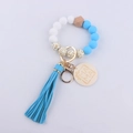 Close-up of silicone beaded keychain bracelet with MAMA wooden tag and blue tassel detail - Blue