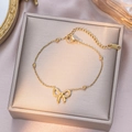 Elegant gold titanium steel bracelet with bow pendant and beads on a jewelry box - Bead Bowknot Bracelet / Gold
