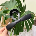 Close-up of a matte black bow-shaped hair claw clip with a sleek frosted resin texture - XL Straight Bow (13.5cm) / Matte Black