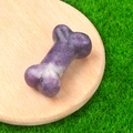 Miniature purple and white crystal bone ornament displayed on a wooden base - Lilac Stone