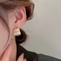 Matte gold rope knot stud earrings with frosted finish on female model's ear - Matte Curved Wide Ear Stud (23# Silver Earring Post-Gold)