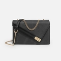 Minimalist black Saffiano leather crossbody bag with asymmetric flap and gold chain strap - Black
