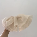 Macro detail of large beige chiffon mesh bow hair clip with layered fairy design - Apricot
