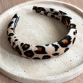 Detailed view of leopard print velvet headband with 'Hand Made' label on stone tray - Large Leopard Beige Yellow