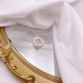 Close-up of French vintage freshwater pearl ring with gold letter J charm on silk - Letter J