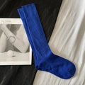 Deep blue ribbed knit knee high socks displayed on minimalist magazine background - Calf-length Klein Blue