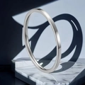 Polished silver stainless steel minimalist 2mm ring displayed on marble stand - US 10 / 1mm / Silver