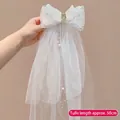 White bow hair clip with 50cm veil featuring sequins, rhinestones and pearl tassels - Angel Wings