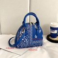 Blue paisley print dome satchel bag showing dimensions of 21cm width and 17.5cm height - Blue