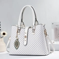 White faux leather handbag with DH monogram print and decorative green leaf pendant - White