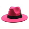 Detail of rose red fedora hat with a black ribbon band and elegant feather accent - Rose Red