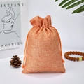 Orange-brown linen drawstring pouch with natural rustic texture for jewelry gifts - Orange