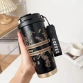 Insulated black stainless steel coffee tumbler with gold lily design and wrist strap - Black & Gold