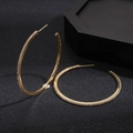Close-up of golden geometric hoop earrings with sparkling white crystals on black background - Hoop Earrings-Gold-5cm