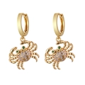 Detailed macro view of gold crab earrings with crystal rhinestones and green gem eyes - Style 25 (Rhinestone Crab)