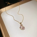 18k gold plated necklace with purple floral gemstone pendant on a white marble display - Necklace-Pink