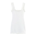 Detailed close-up of white knit sleeveless dress with ruffled edges and pearl embellishments - S / White