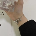 Silver layered metal chain bracelet featuring star and heart charms on model - Little Cow Star Necklace