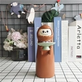 Brown monster design electric coin bank with a green tray in a cozy home setting - Brown Monster Model