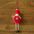 Plush Christmas elf ornament with red knit hat and golden heart on a wood background - B-Style Red