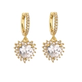 Detailed view of heart-shaped gold-plated hoop earrings with sparkling zircon stones - Gold Heart