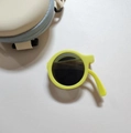 Foldable yellow round kids sunglasses with a matching beige circular storage case - Light Yellow