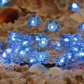 Blue crab LED string light with translucent blue plastic shells on warm beach sand - Blue Crab