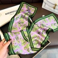 Green silk skinny scarf with purple floral pattern shown neatly in a gift box - The Wizard of Oz Green