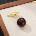 Cute cherry shaped brooch in deep red and gold finish on a natural linen background - Style 8 (Wine Red/Gold)