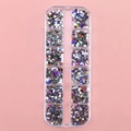 12-grid storage box with diverse colorful resin and glass nail art charms on pink backdrop - 12 Types Mixed Shapes Colors Rhinestones