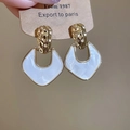 Close-up of vintage geometric shield earrings with white pearlescent inlay and gold frame - 925 Sterling Silver Earring Post - White
