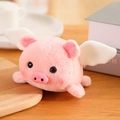 Pink plush pig toy with white wings and soft fuzzy texture in a cozy home setting - Pig 12cm