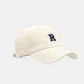 Détail d'une casquette crème avec broderie R bleu marine et visière incurvée classique - Beige