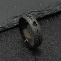 Macro shot of black matte ring with heartbeat EKG cutout on a dark stone background - Black EKG Heartbeat (6mm)
