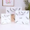 Set of three white paper gift bags with silver feather prints and ribbon handles - Small (14*7*15cm) / Silver Feather
